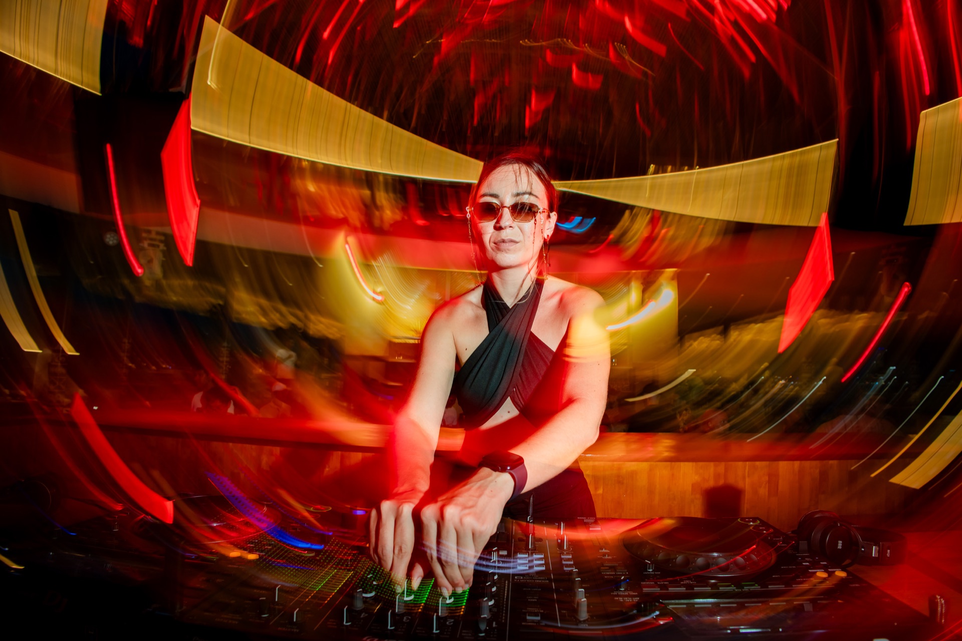 After dark — a DJ on the decks under warm lights