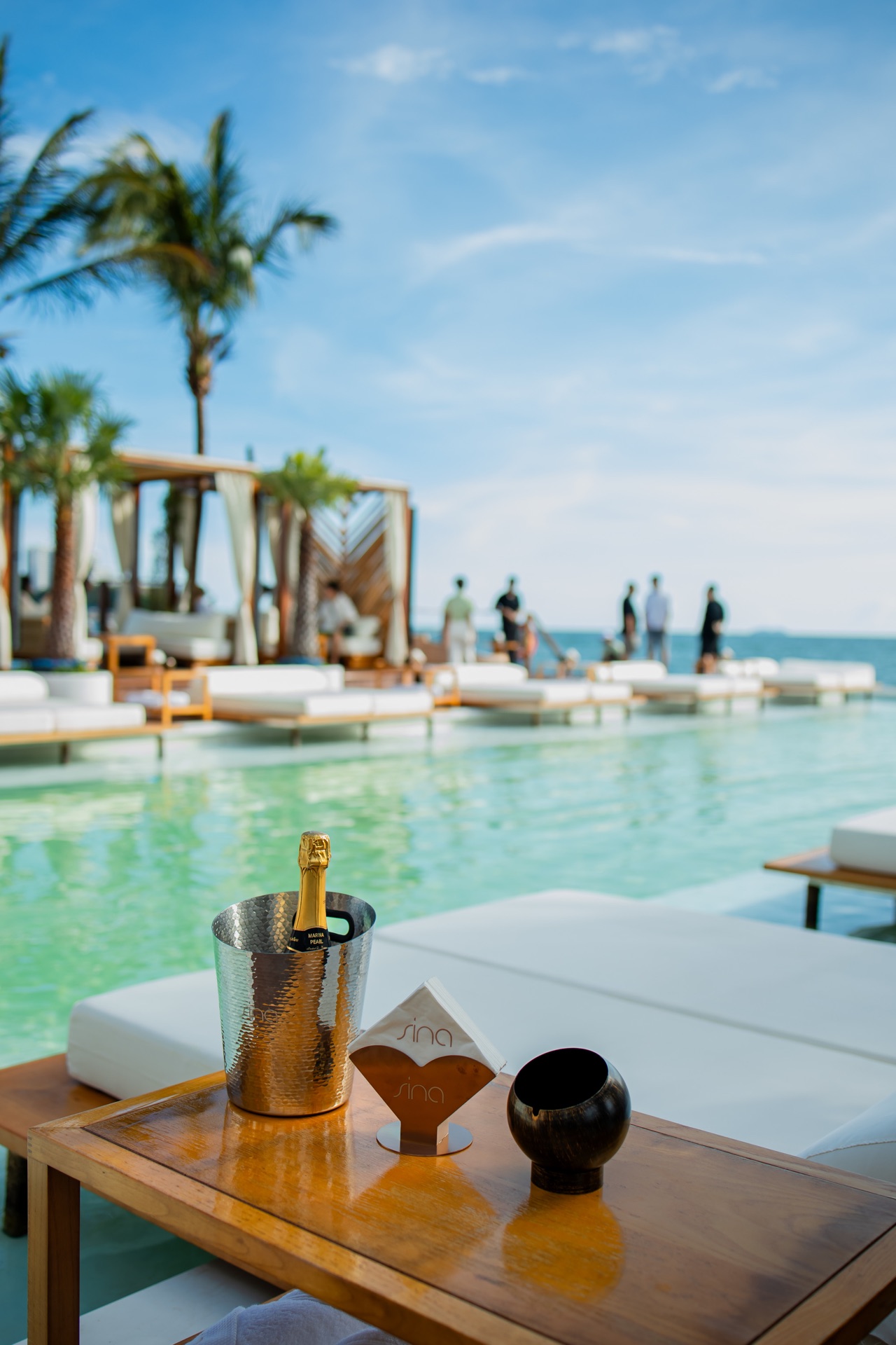 Champagne chilling on a sea-view daybed by the infinity pool